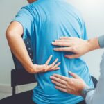 Doctor consulting with patient Back problems Physical therapy concept