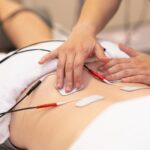 Electro stimulation in physical therapy to a young woman