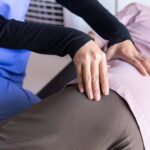 Physiotherapist doing treatment low-back lumbar pain to senior woman,Physical therapy concept